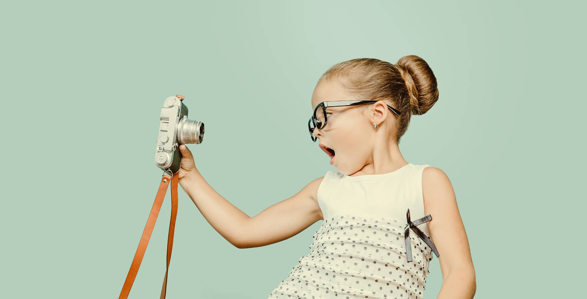 junges Mädchen das ein Foto (selfie) mit einer alten Kamera von sich macht